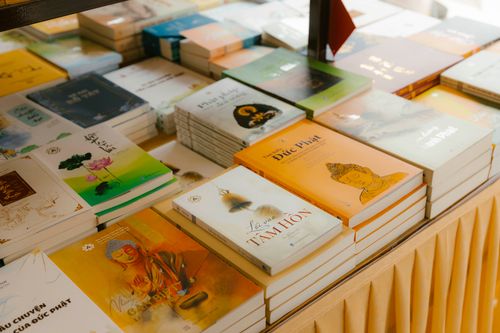 Free A diverse collection of books neatly arranged on a table indoors. Stock Photo