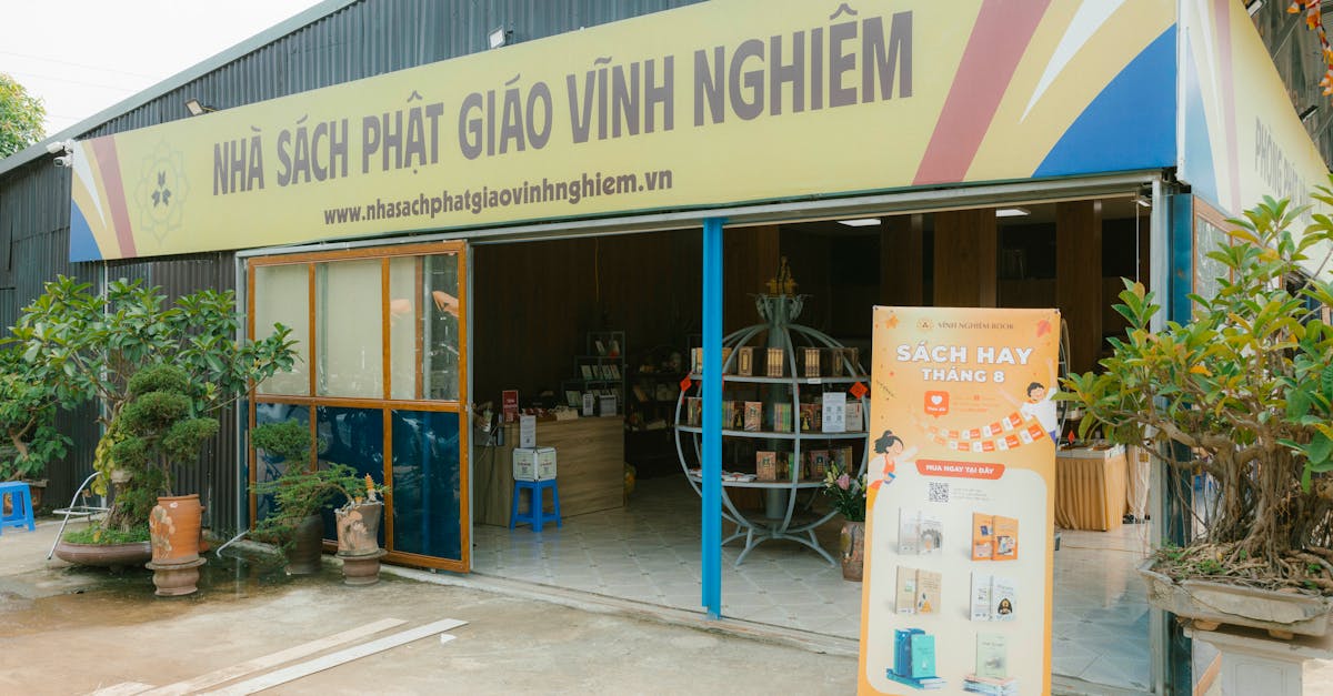Entrance of Vĩnh Nghiêm bookstore in Vietnam, showcasing books and plants.