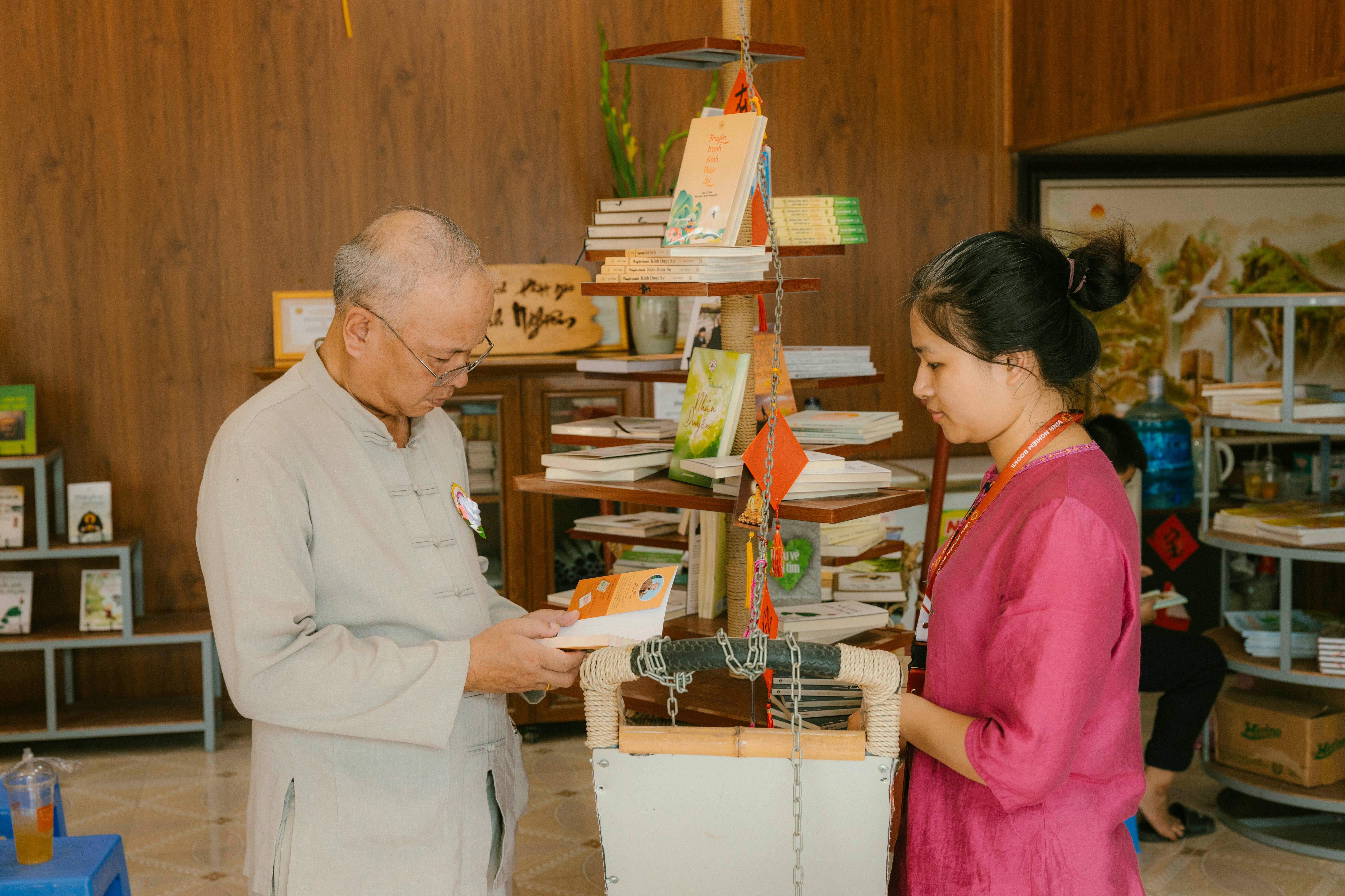 Mitä Intrum tekee? - Two people examining books in a cozy indoor setting, suggesting learning or relaxation.