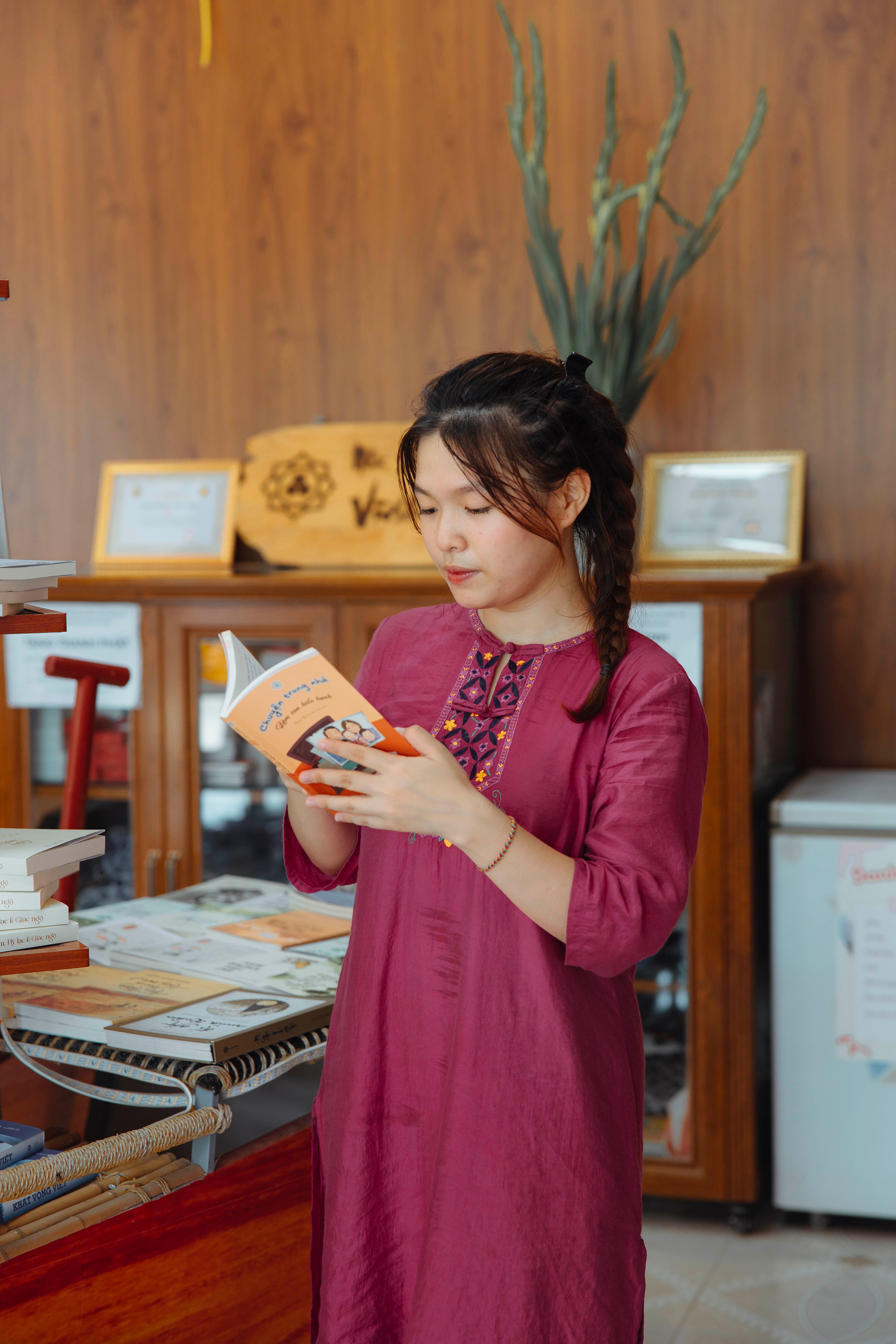 A woman in a red dress is reading a book · Free Stock Photo