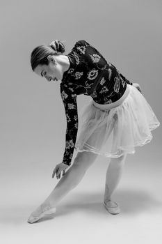 Black and white portrait of a ballerina posing gracefully, showcasing classic dance elegance.