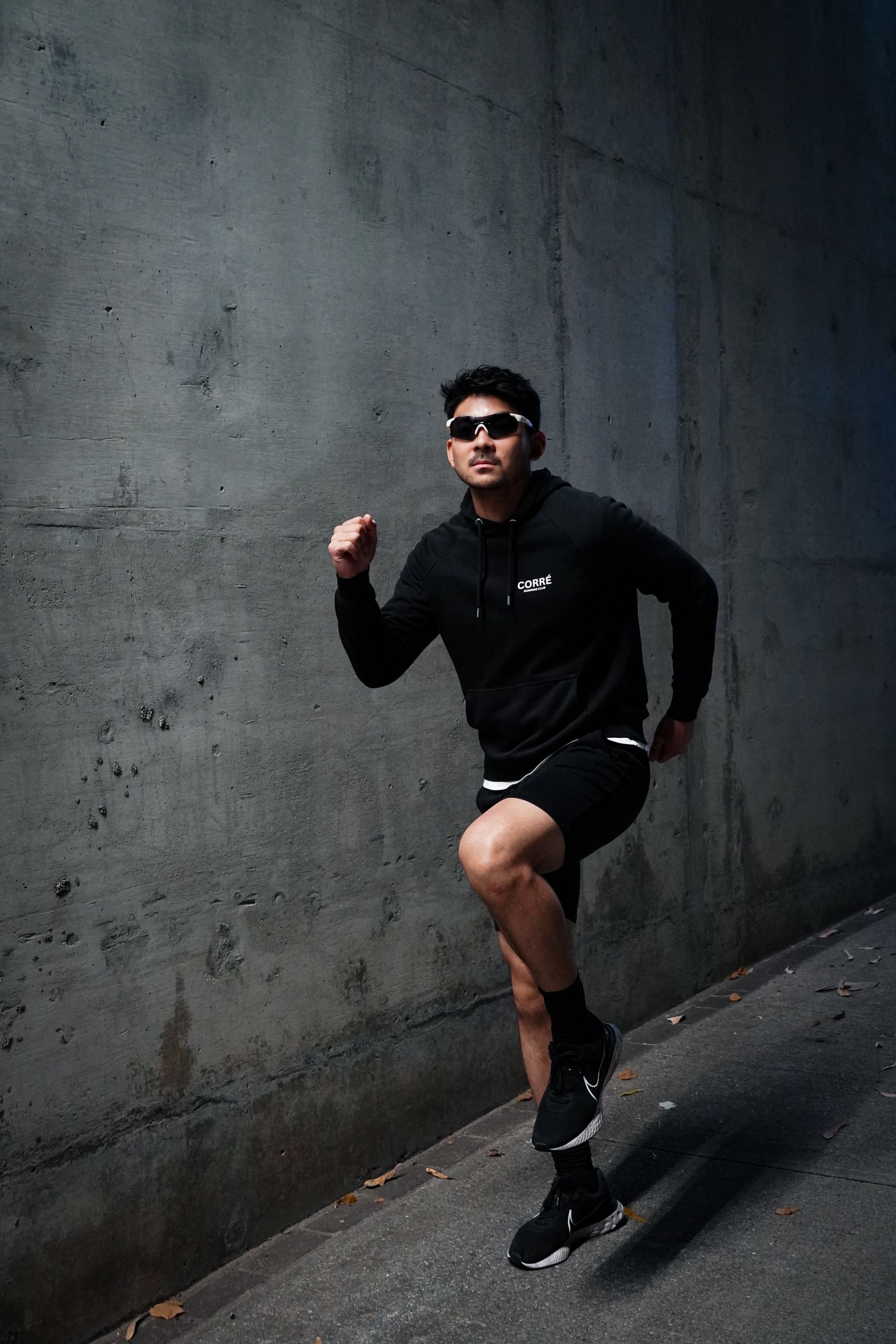 Man running in dark technical performance layers