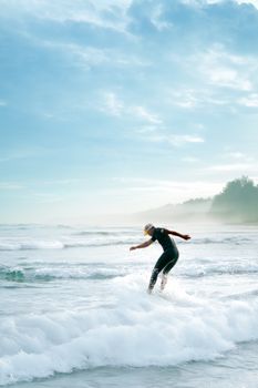 A surfer in action on the waves at Playas de Rosarito, Mexico, under a bright summer sky.
