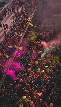 Vibrant aerial capture of Holi festival with colorful powder in Vrindavan, India.