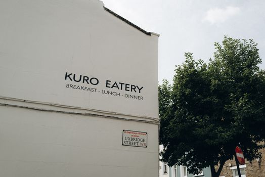 Street view of Kuro Eatery on Uxbridge Street in Notting Hill, London.