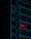 A red light is shining through the window of a building
