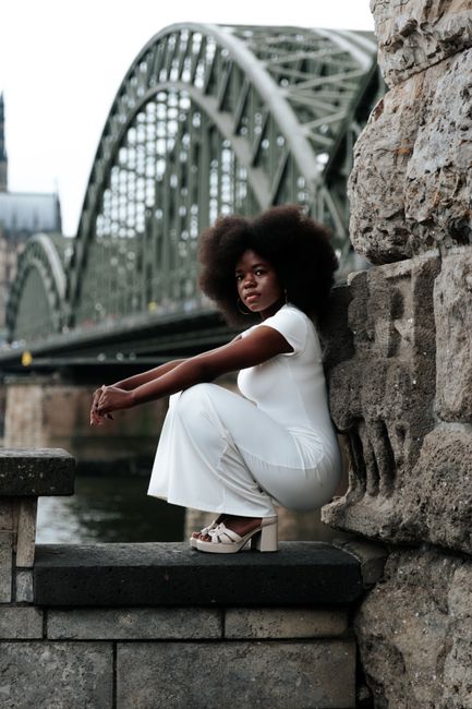 Portrait of a stylish woman by the Hohenzollern Bridge in Cologne, Germany.