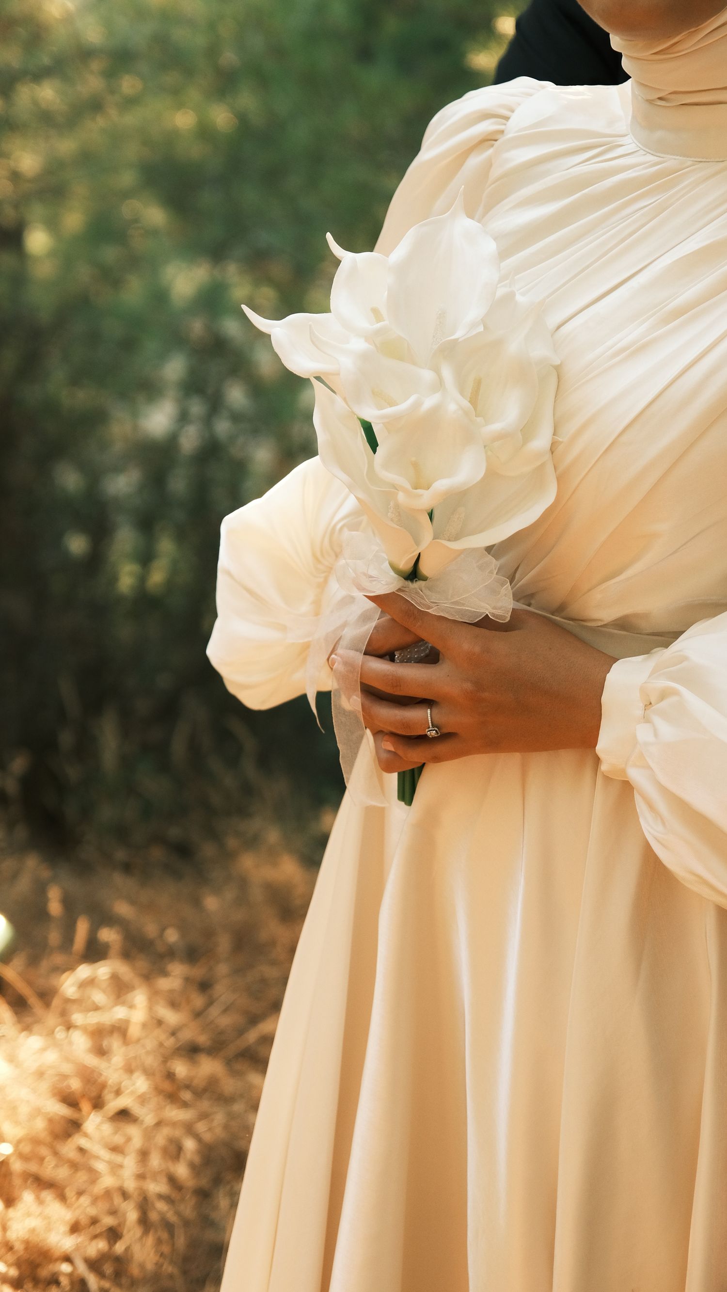 Bride holding white flowers in an elegant gown