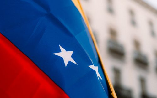 Free Close-up of the vibrant Venezuelan flag with stars in an urban environment, symbolizing national pride. Stock Photo