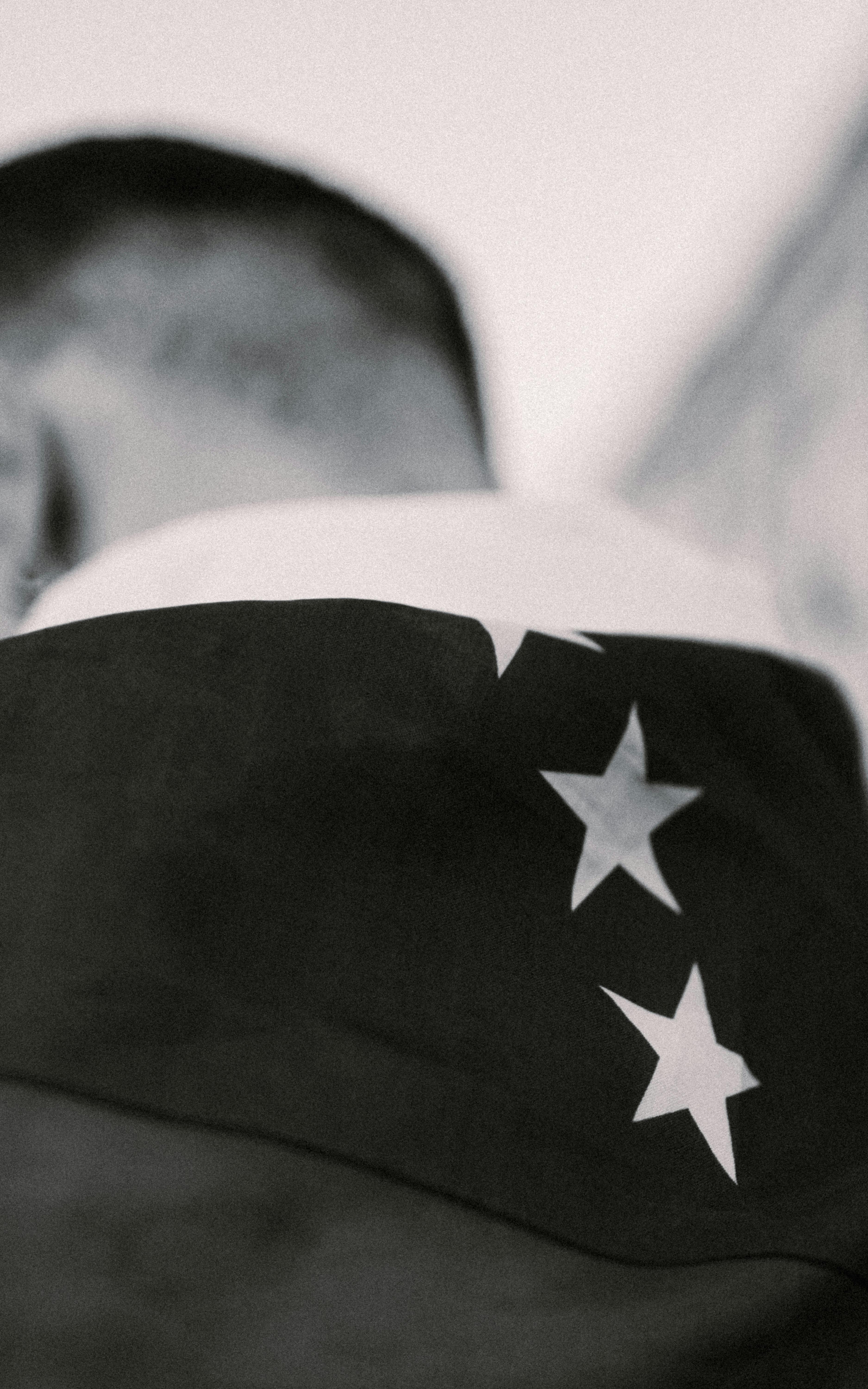 a black and white photo of a man with stars on his back