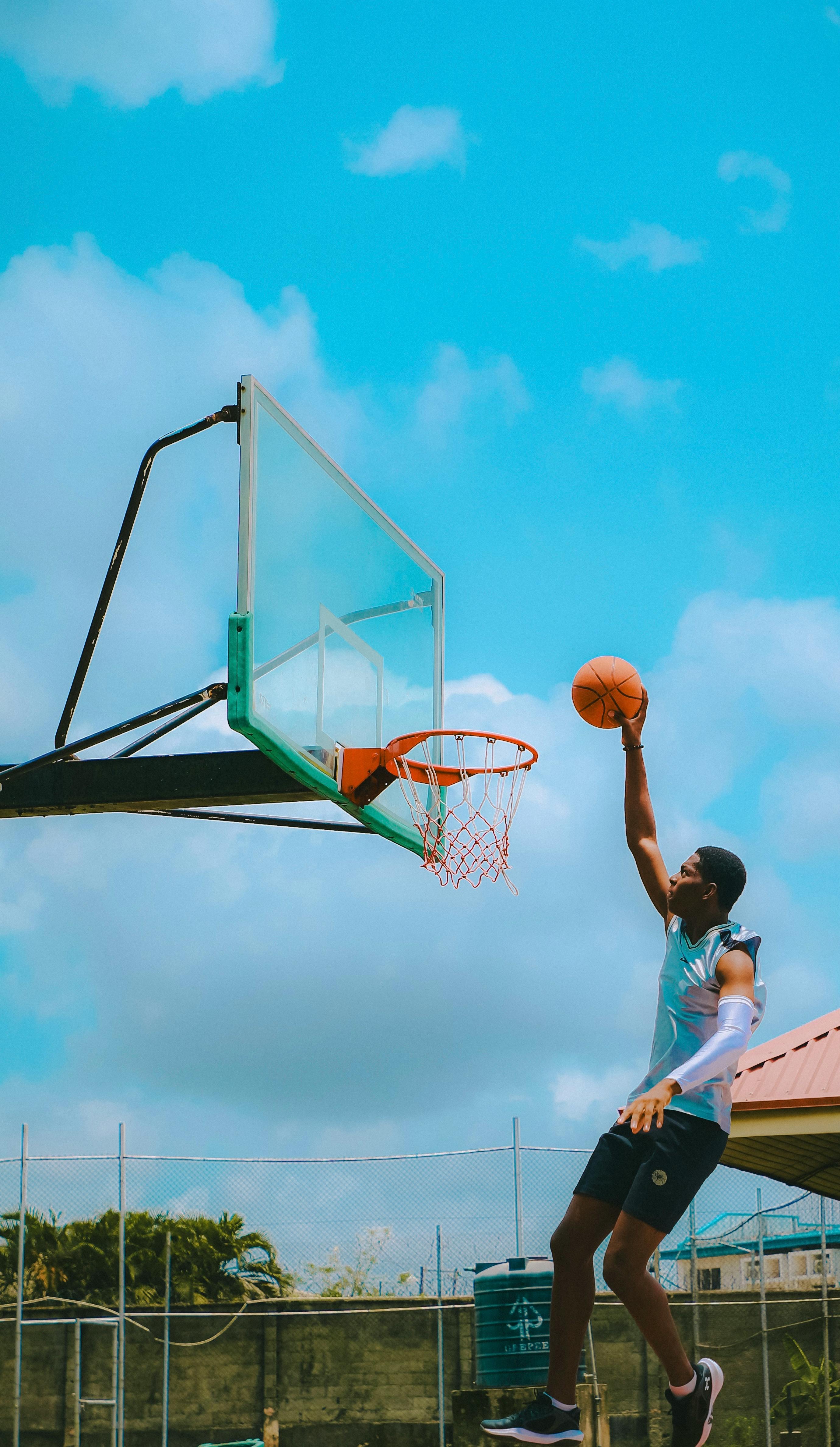 a man is playing basketball in the air