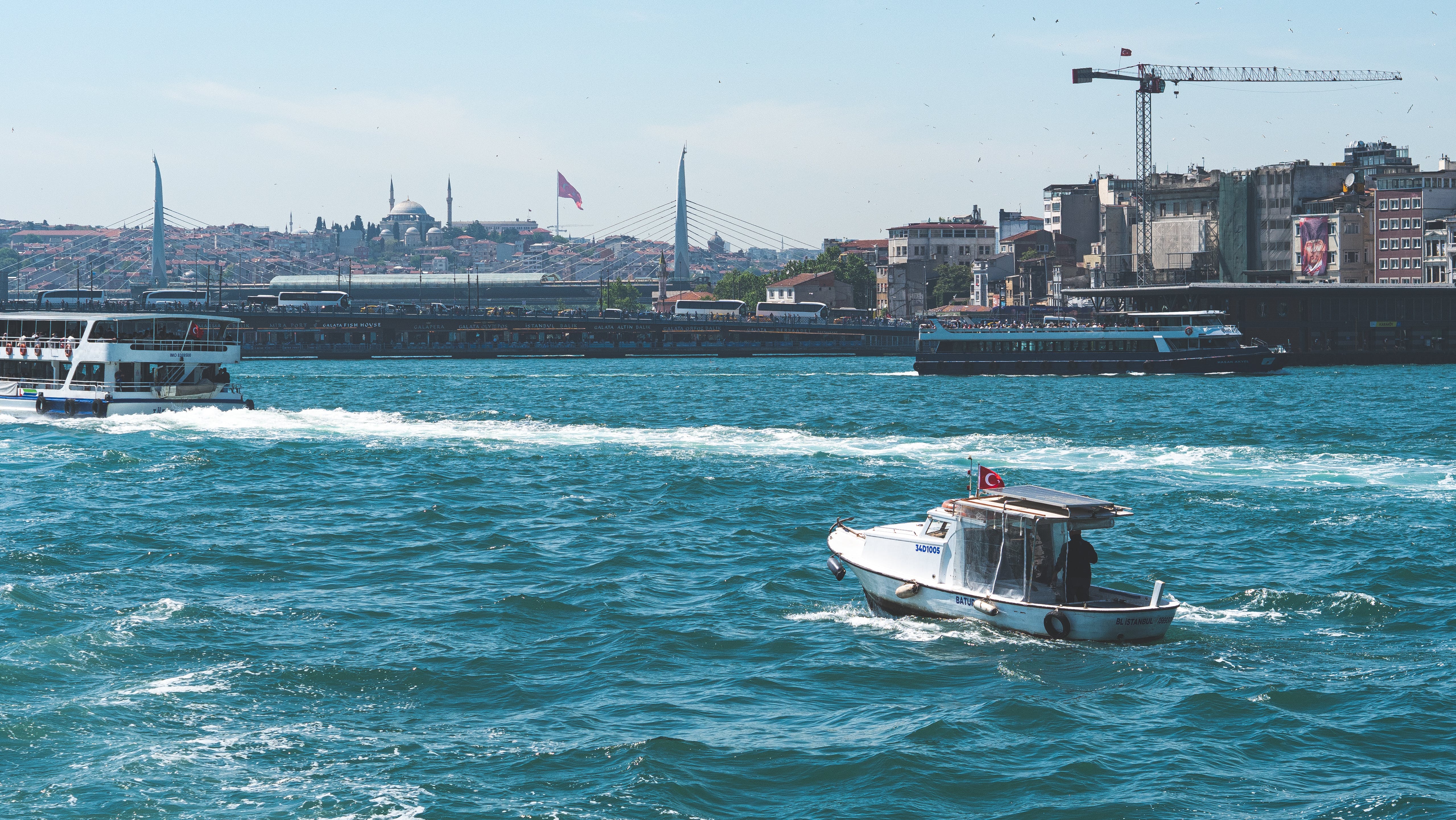 a boat traveling through the water near a city