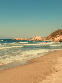 A tranquil beach scene with clear skies and gentle waves perfect for a summer escape.