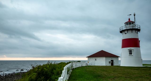 Coastal lighthouse under a heavy sky — photo by Jason Sherrod on Pexels