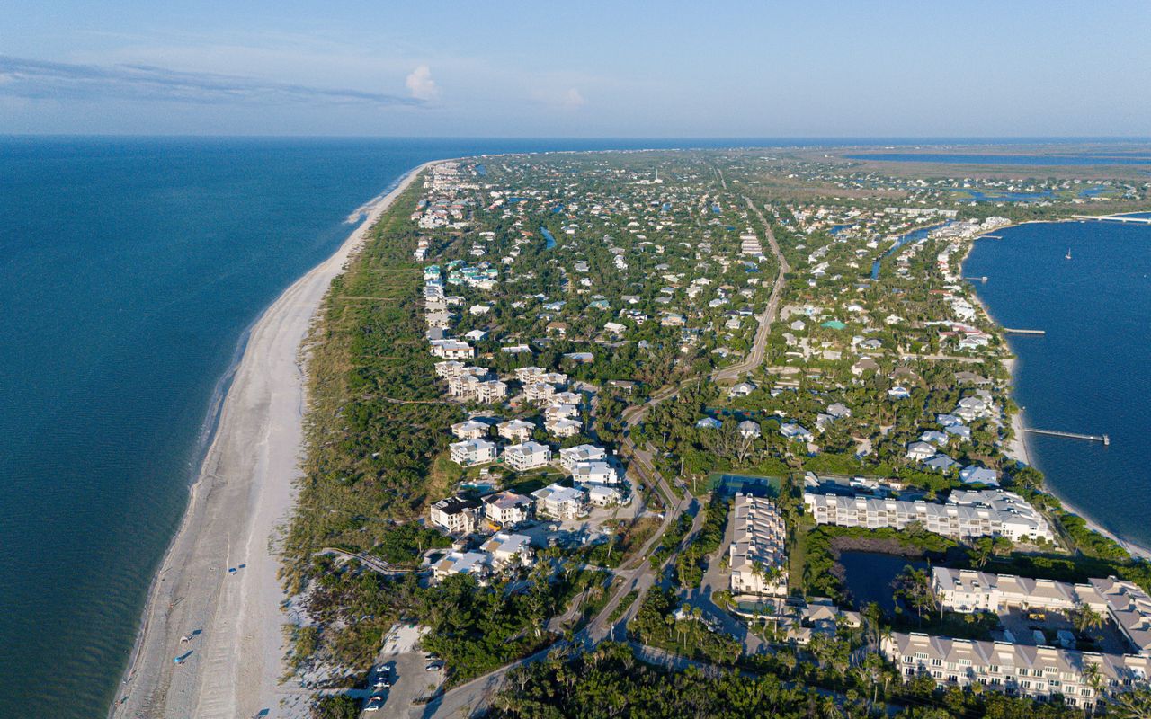 Stunning aerial photo of Sanibel Island, FL, showcasing the coastline and residential areas.
