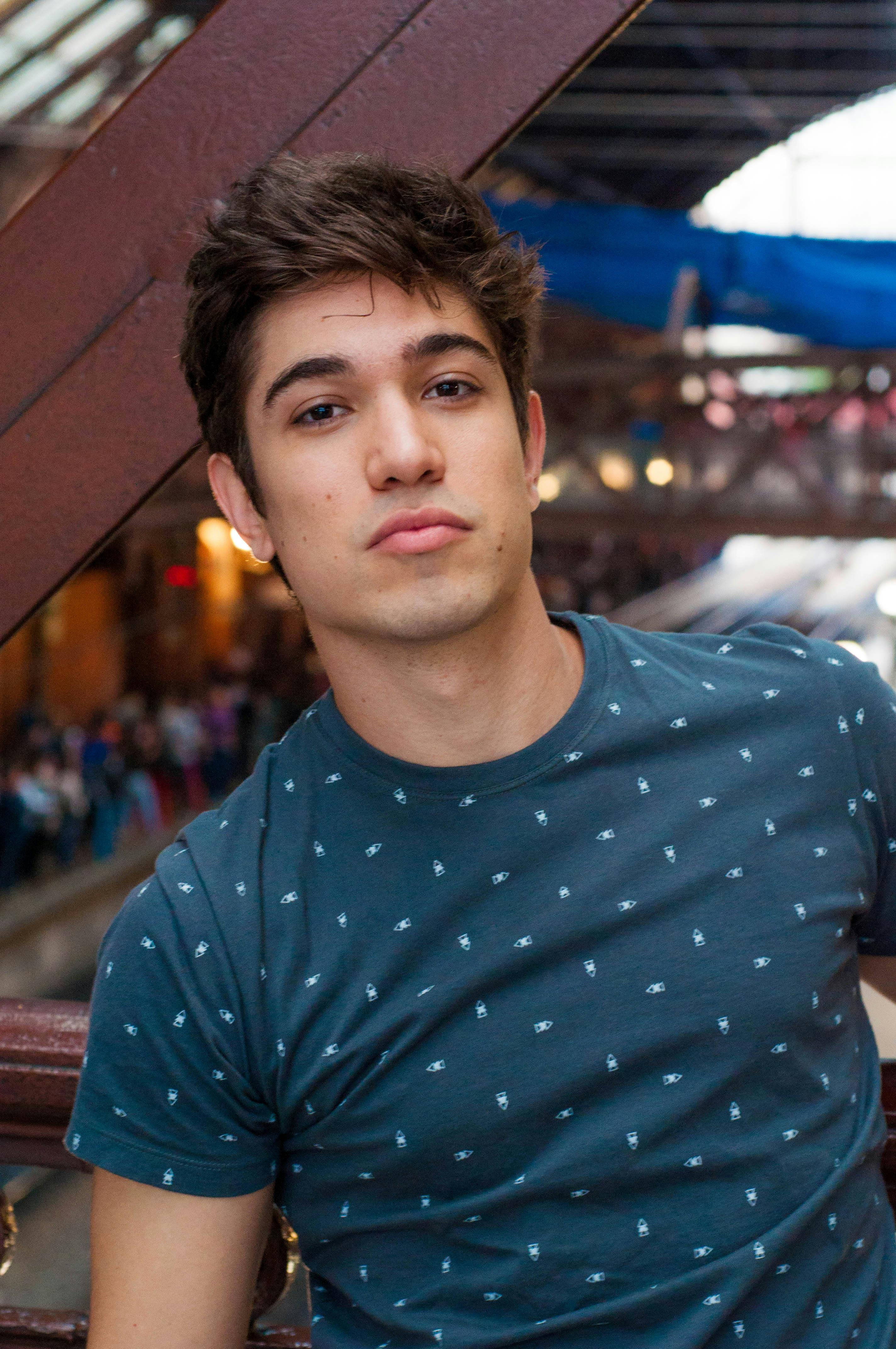Portrait of a fashionable young man in a casual setting, exuding confidence and youthfulness.