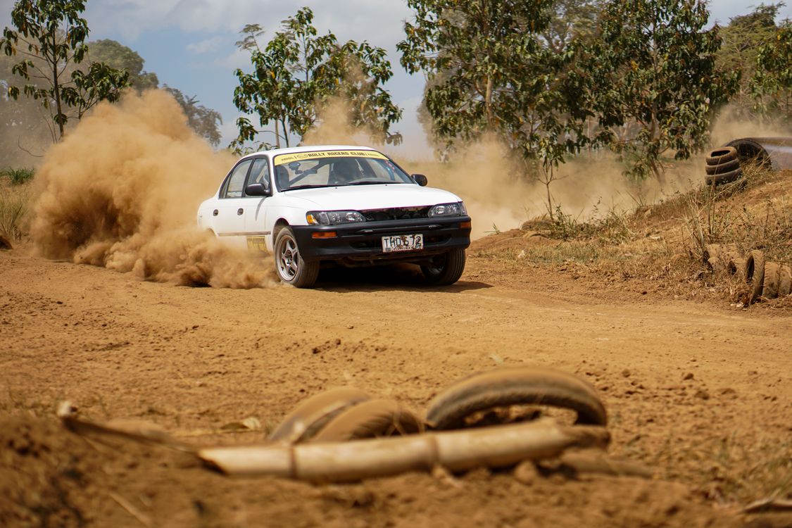 Dust Rally Road A car driving on a dirt road with dust flying up · Free Stock Photo