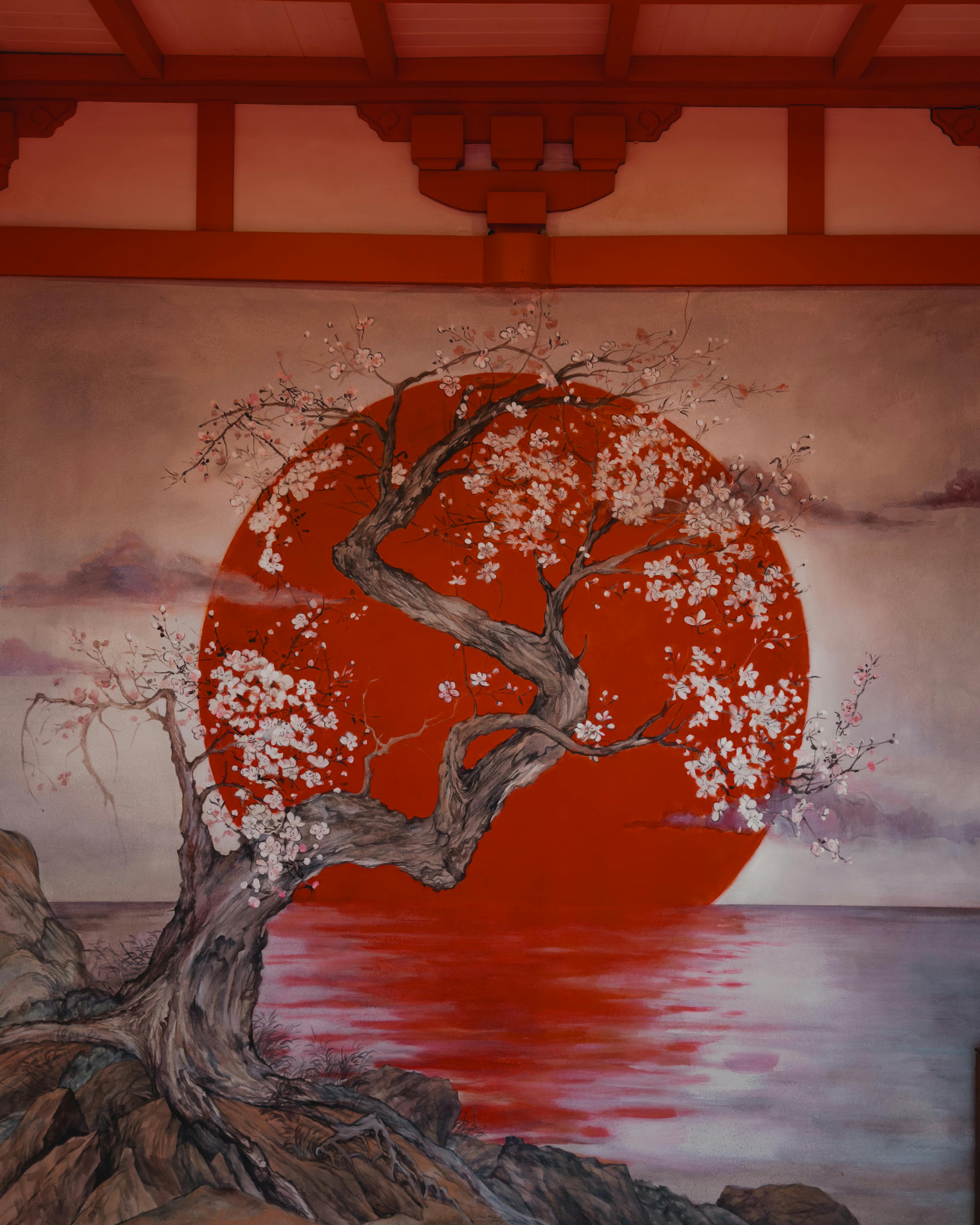 a painting of a tree and a red sun