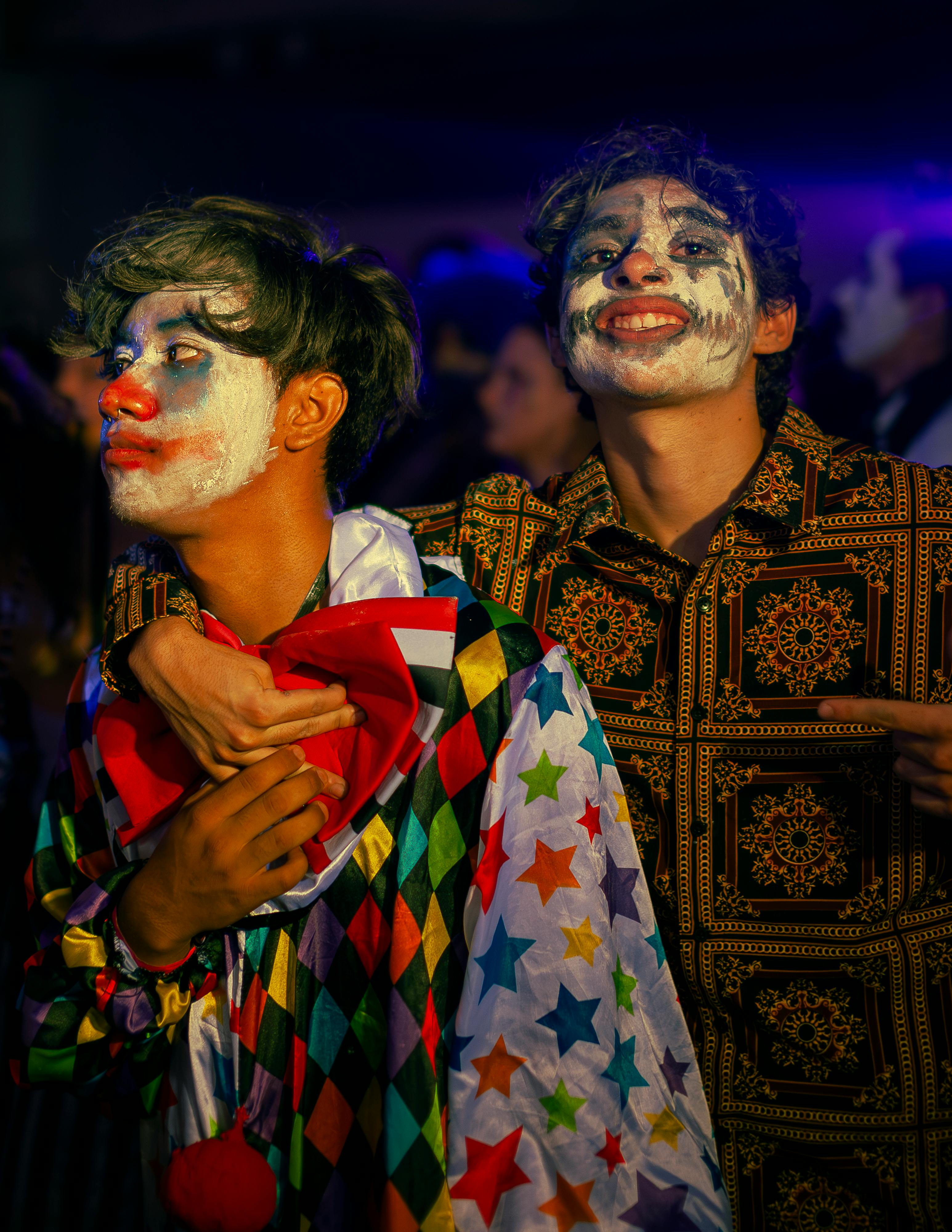 two men dressed as clowns at a party