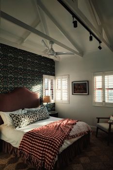 A warm and inviting bedroom featuring vintage decor and natural lighting, perfect for relaxation.