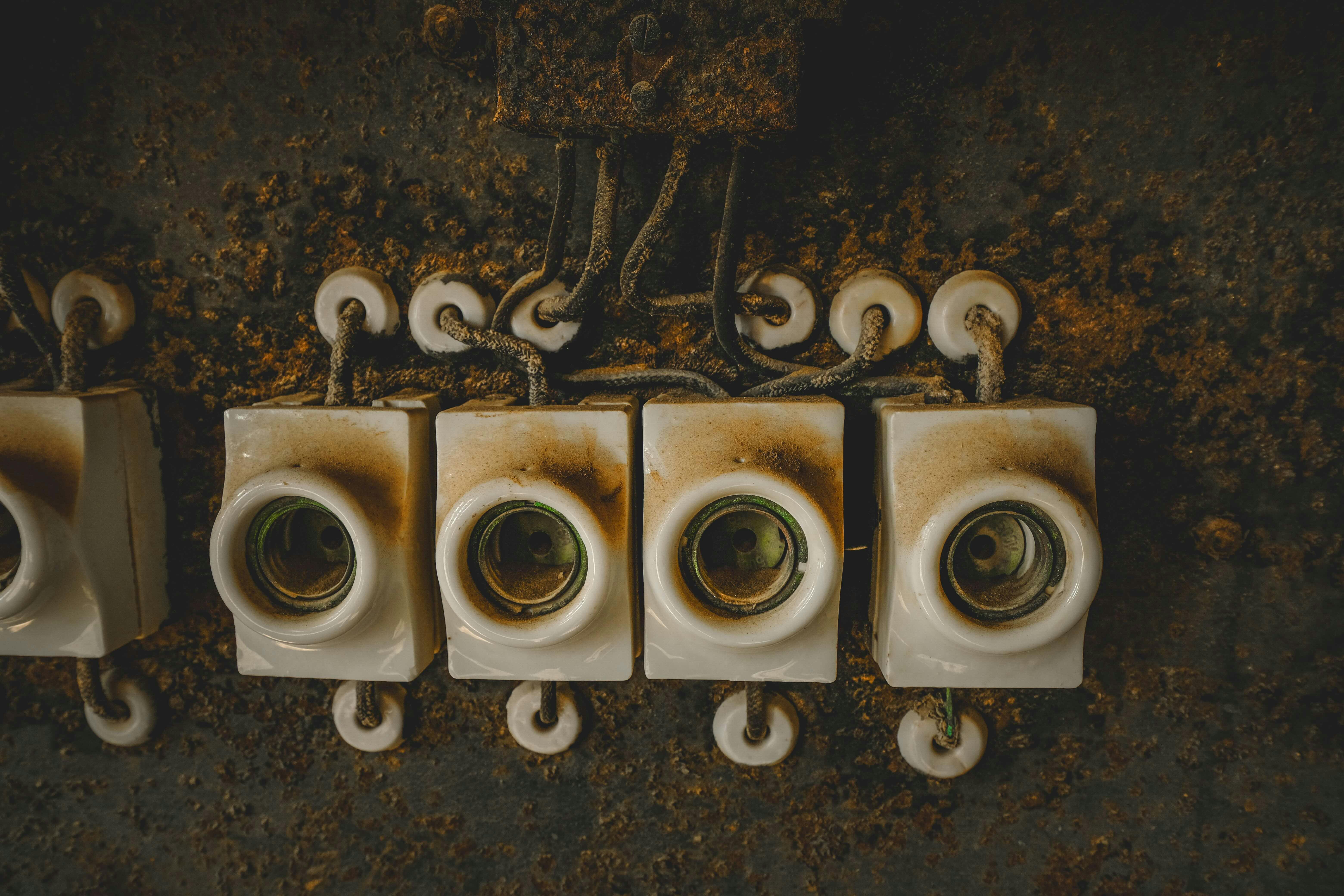 a close up of four electrical sockets on a wall