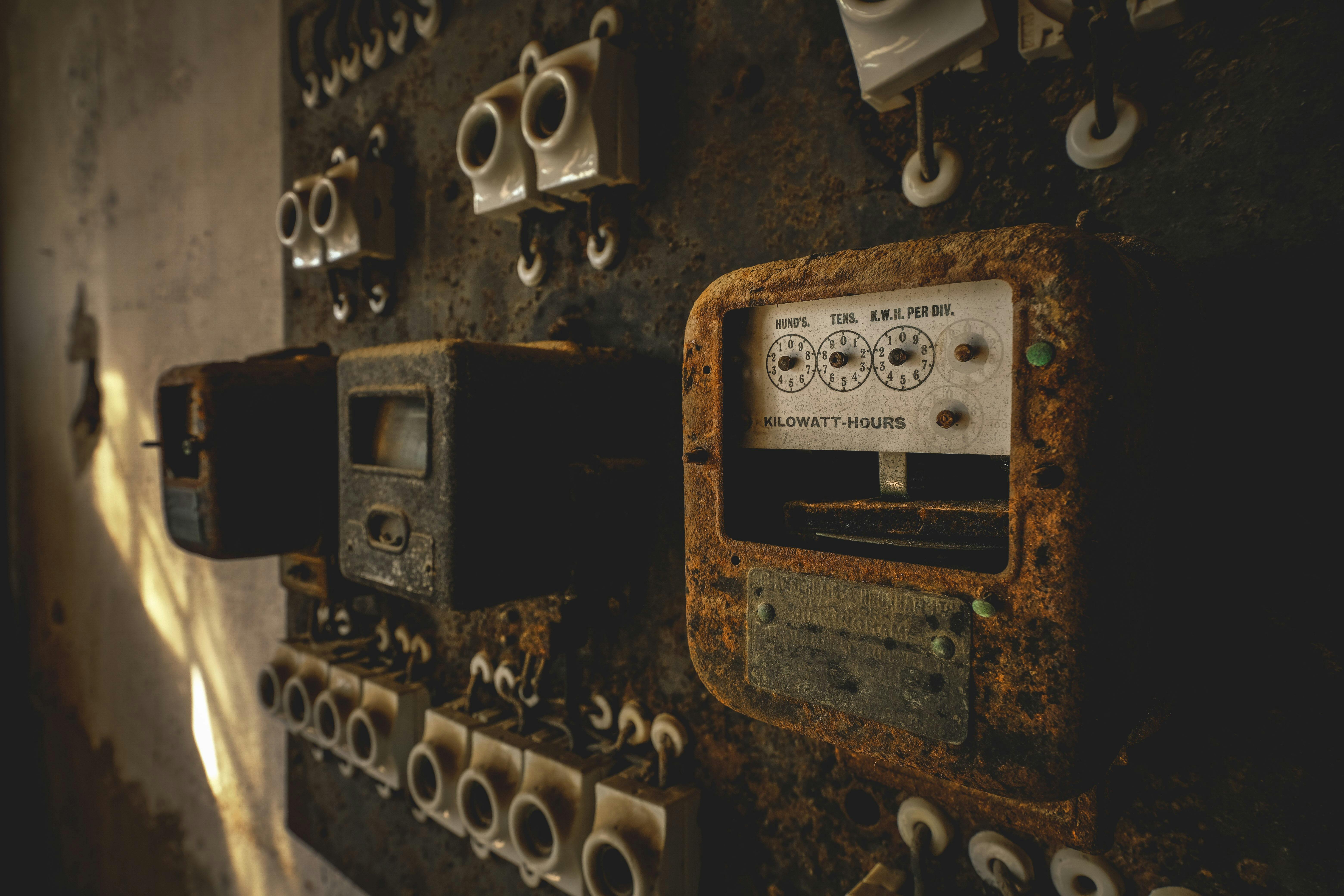 An old electrical panel with several switches and wires