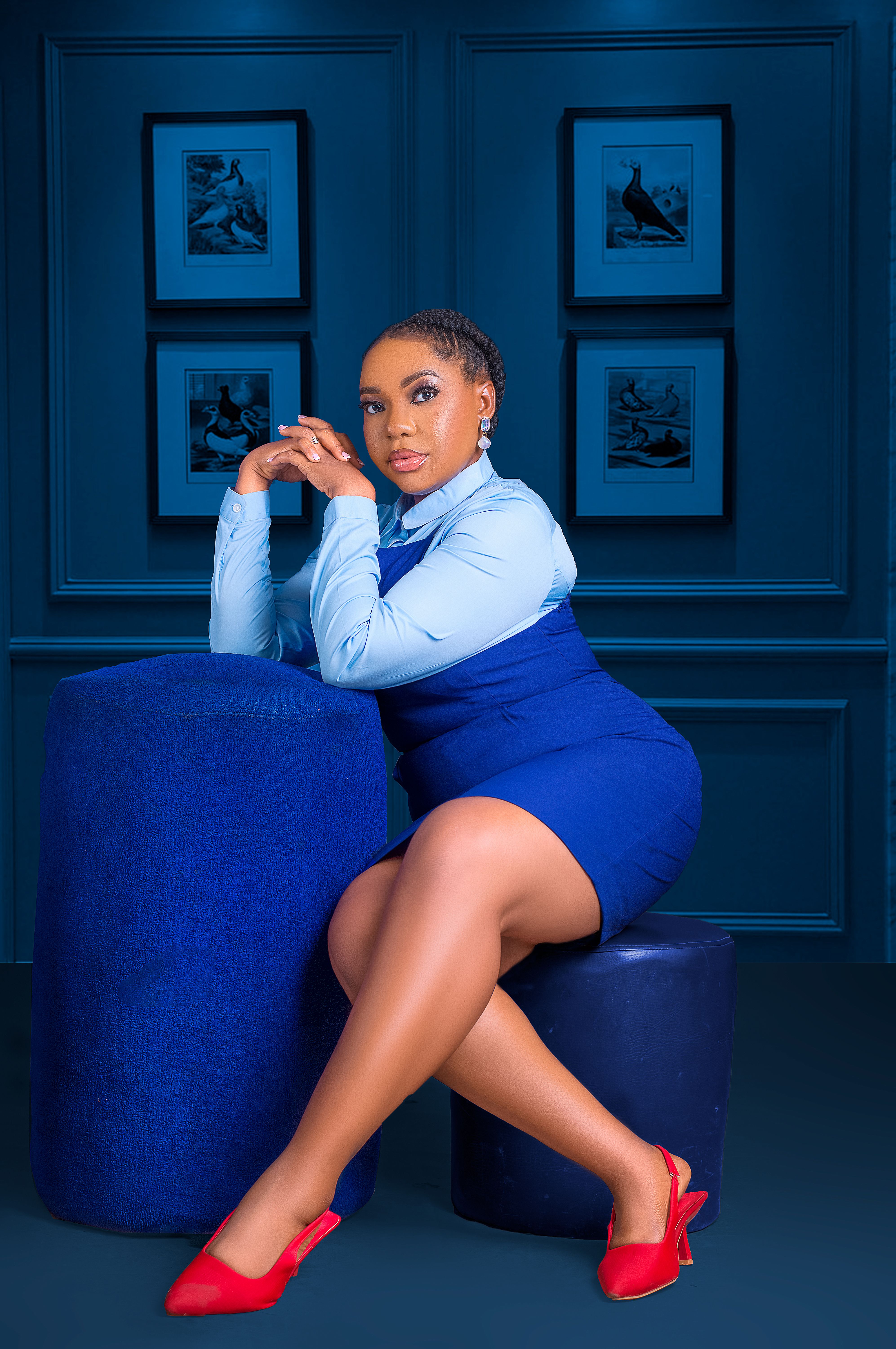 A woman in a blue dress sitting on a blue stool · Free Stock Photo