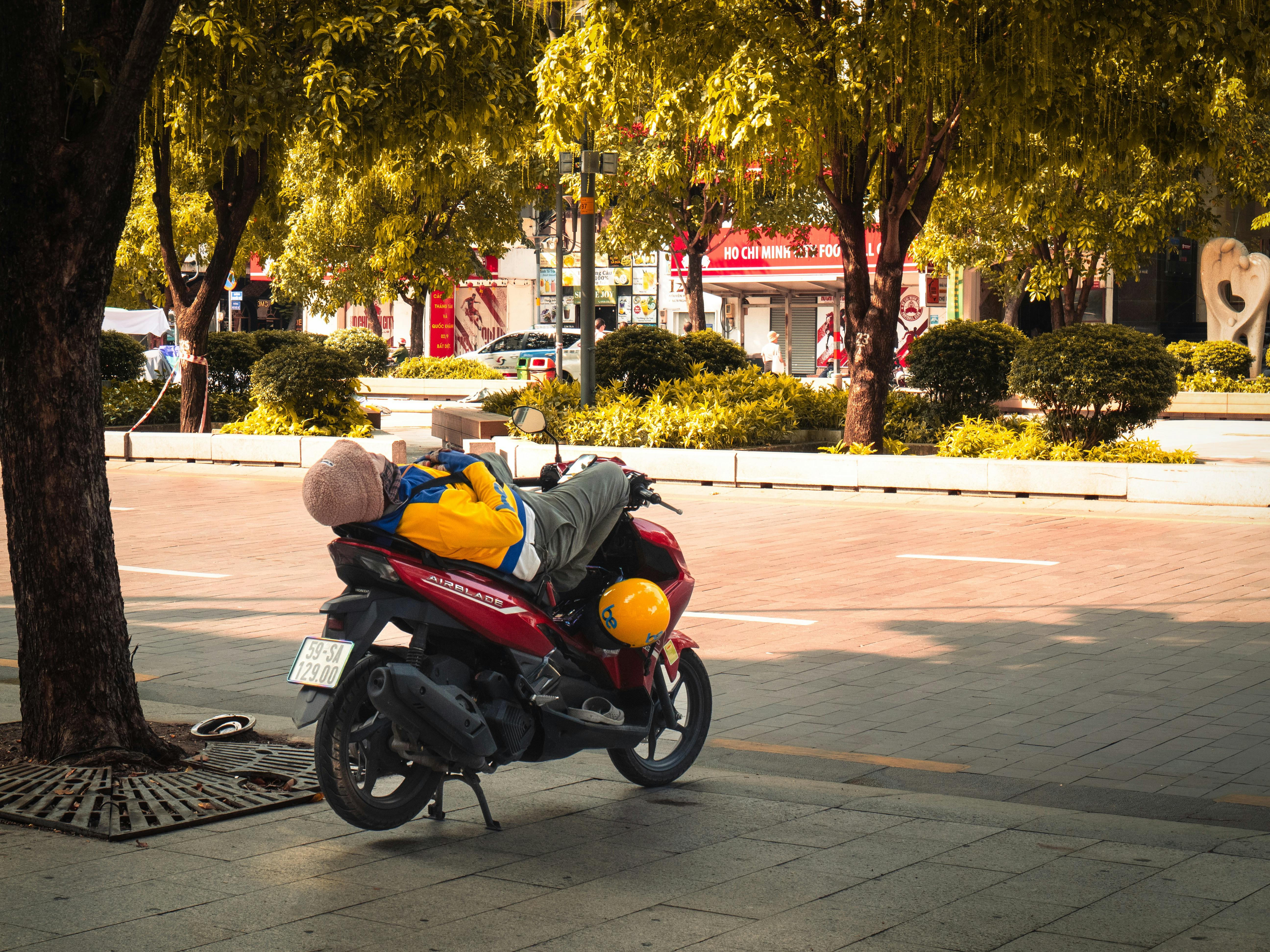 a man is riding a motorcycle with a stuffed animal on it