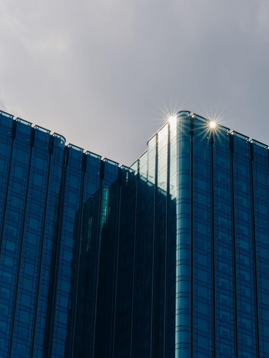 Building In The Sun A close up of a building with the sun shining through it · Free Stock Photo