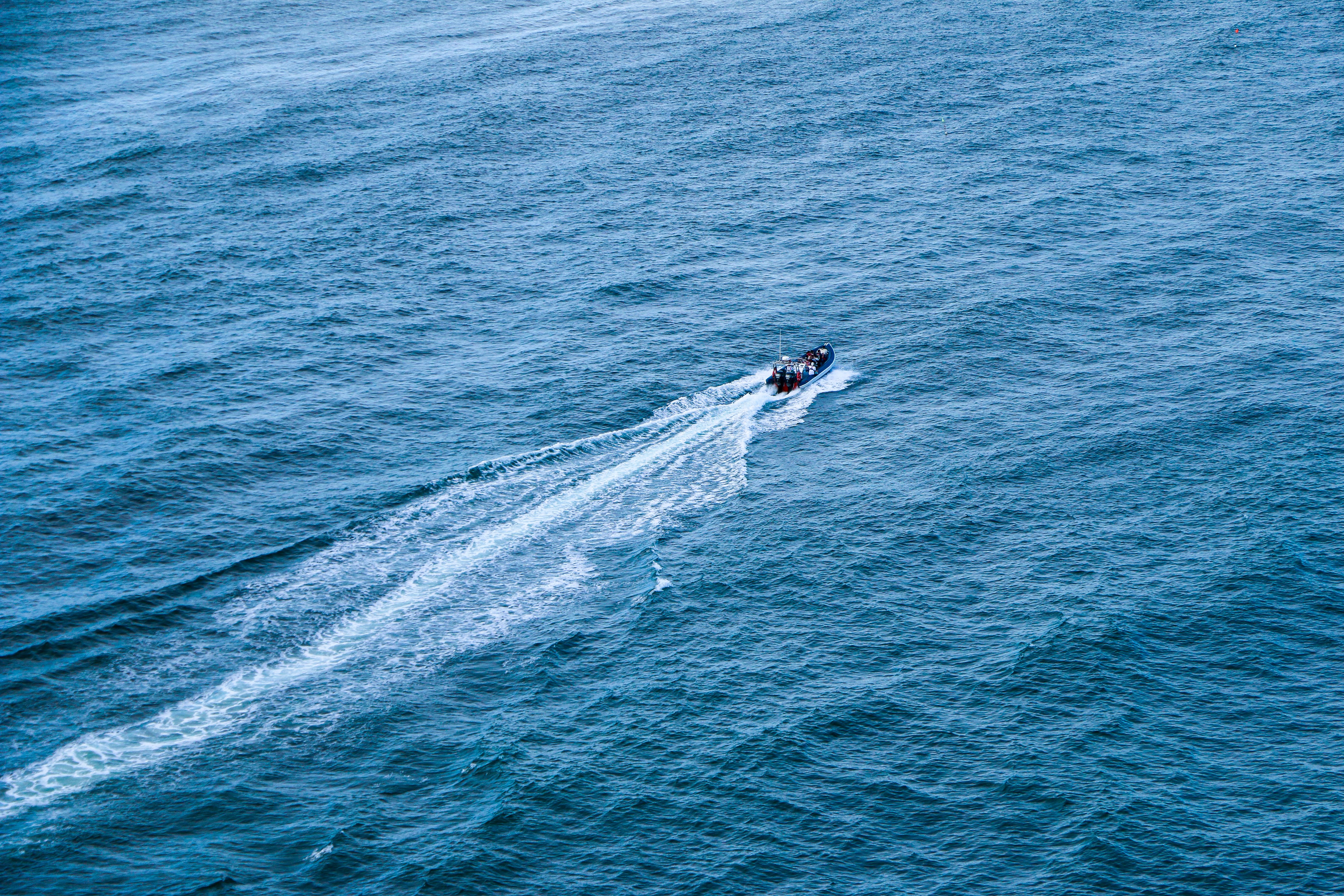 A person riding a jet ski in the ocean · Free Stock Photo