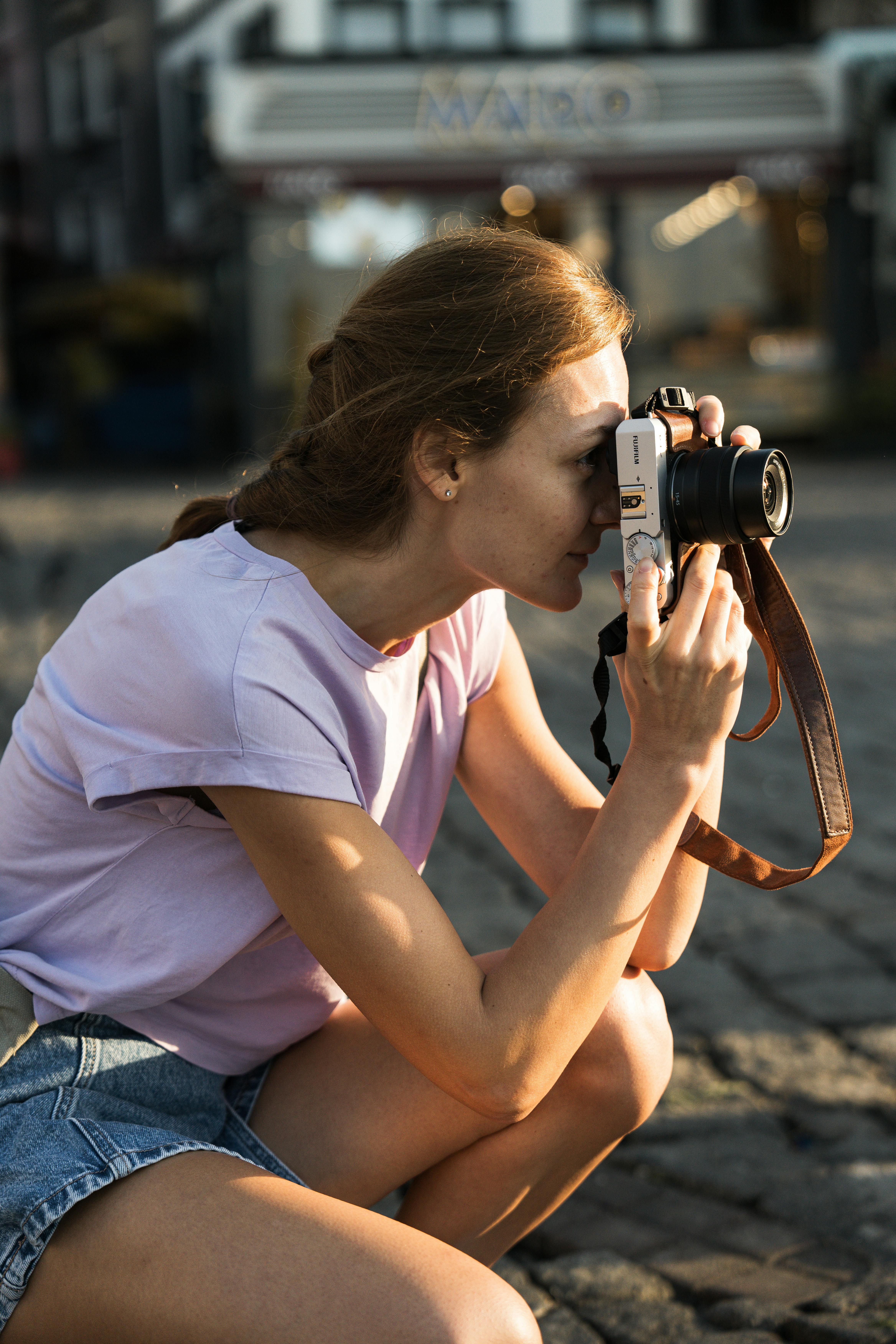 woman crouching and taking pictures