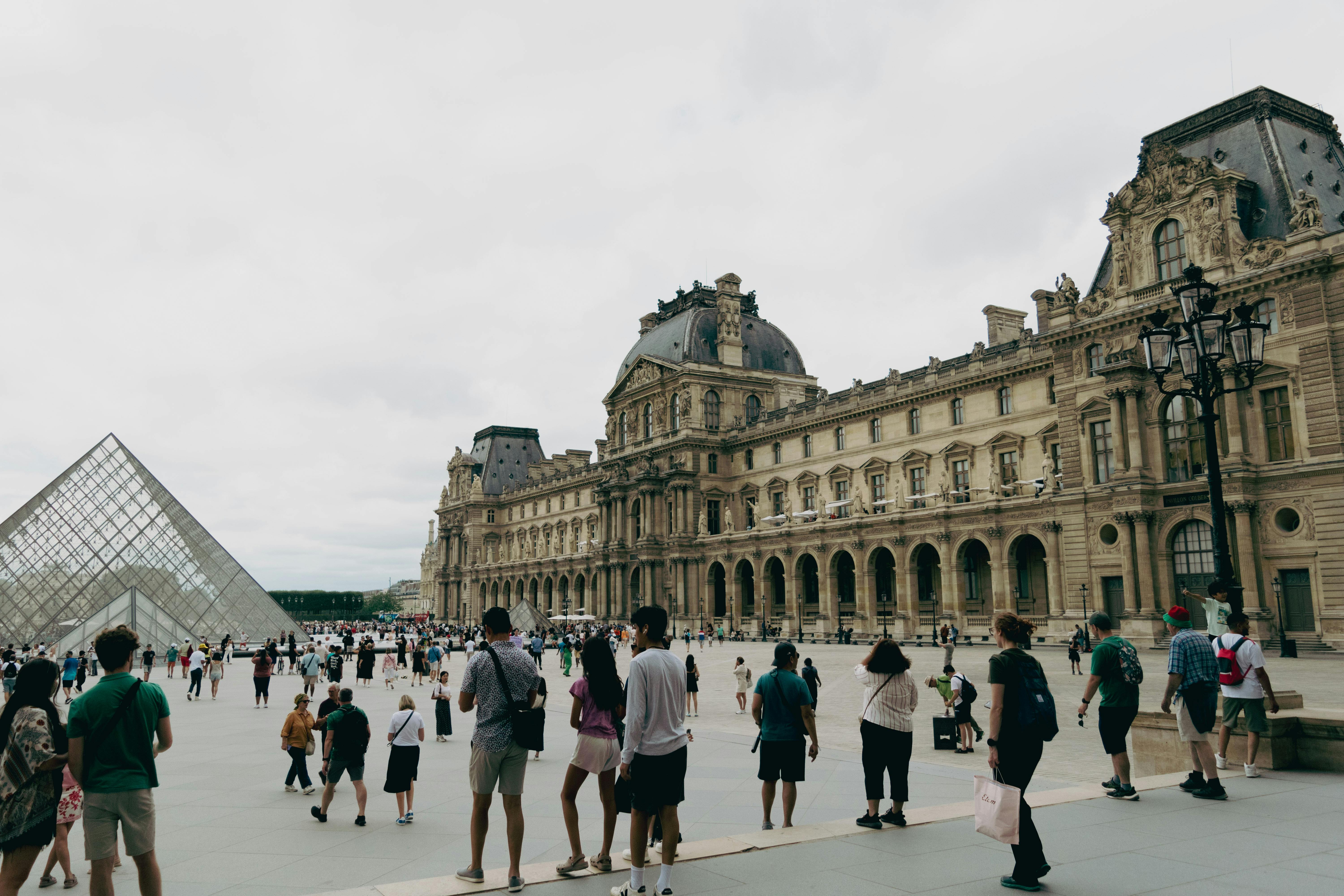 people walking around the louvre in paris