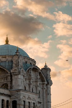 Stunning view of Ortaköy Mosque against a colorful sunset in Istanbul, Türkiye.