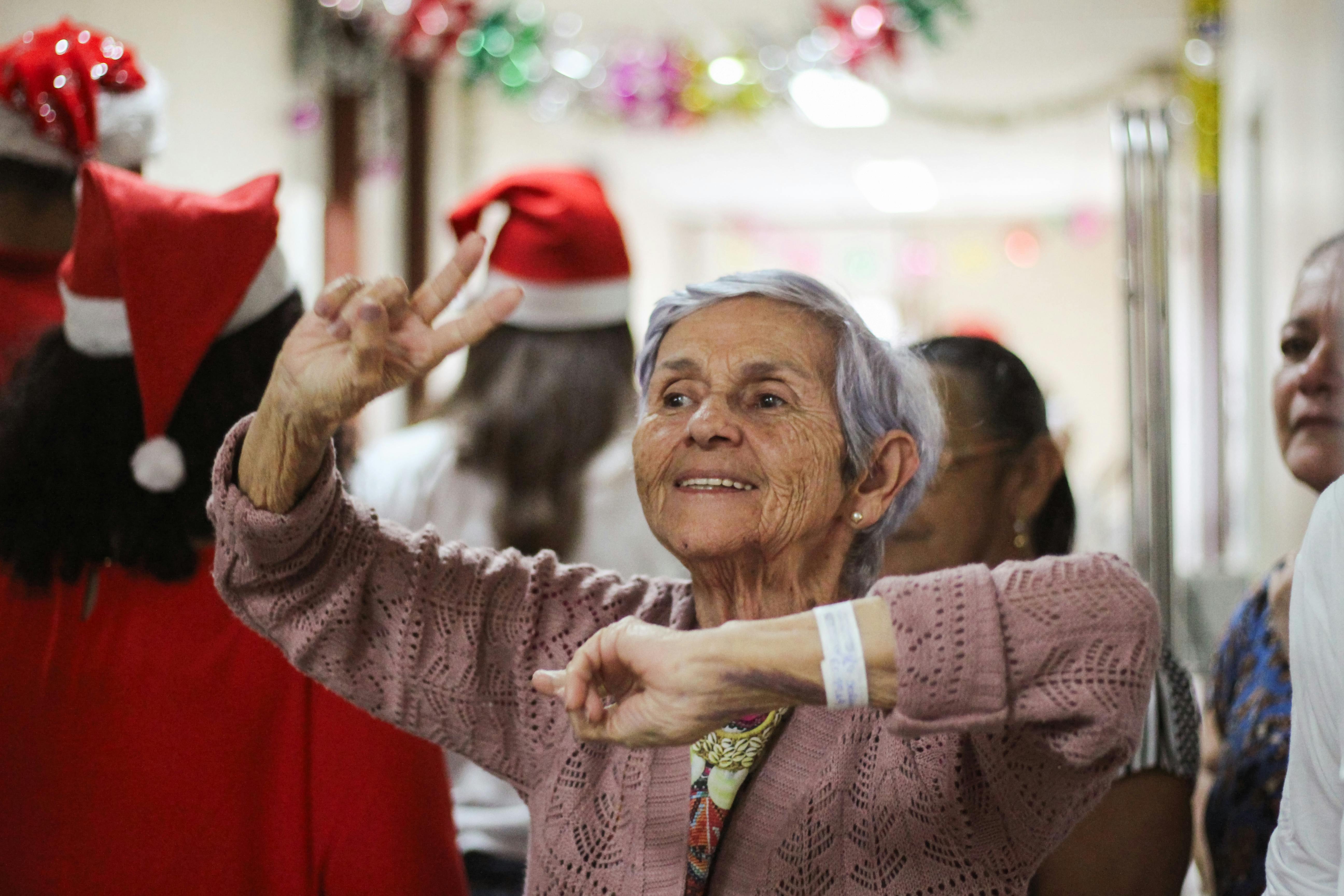 an older woman is dancing in a hospital