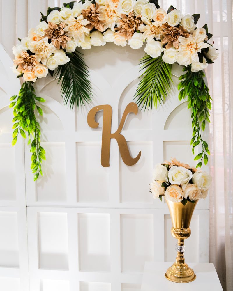 Floral arrangement over a golden initial letter