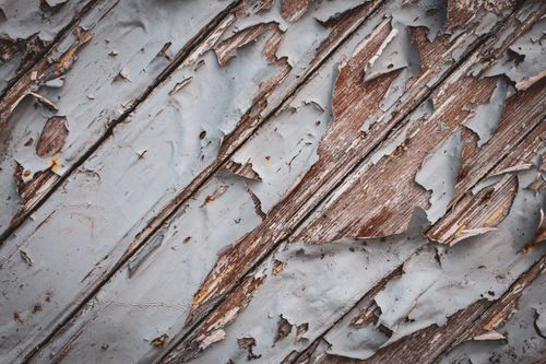 Free A detailed view of peeling paint revealing weathered wood texture, showcasing decay and rustic charm. Stock Photo