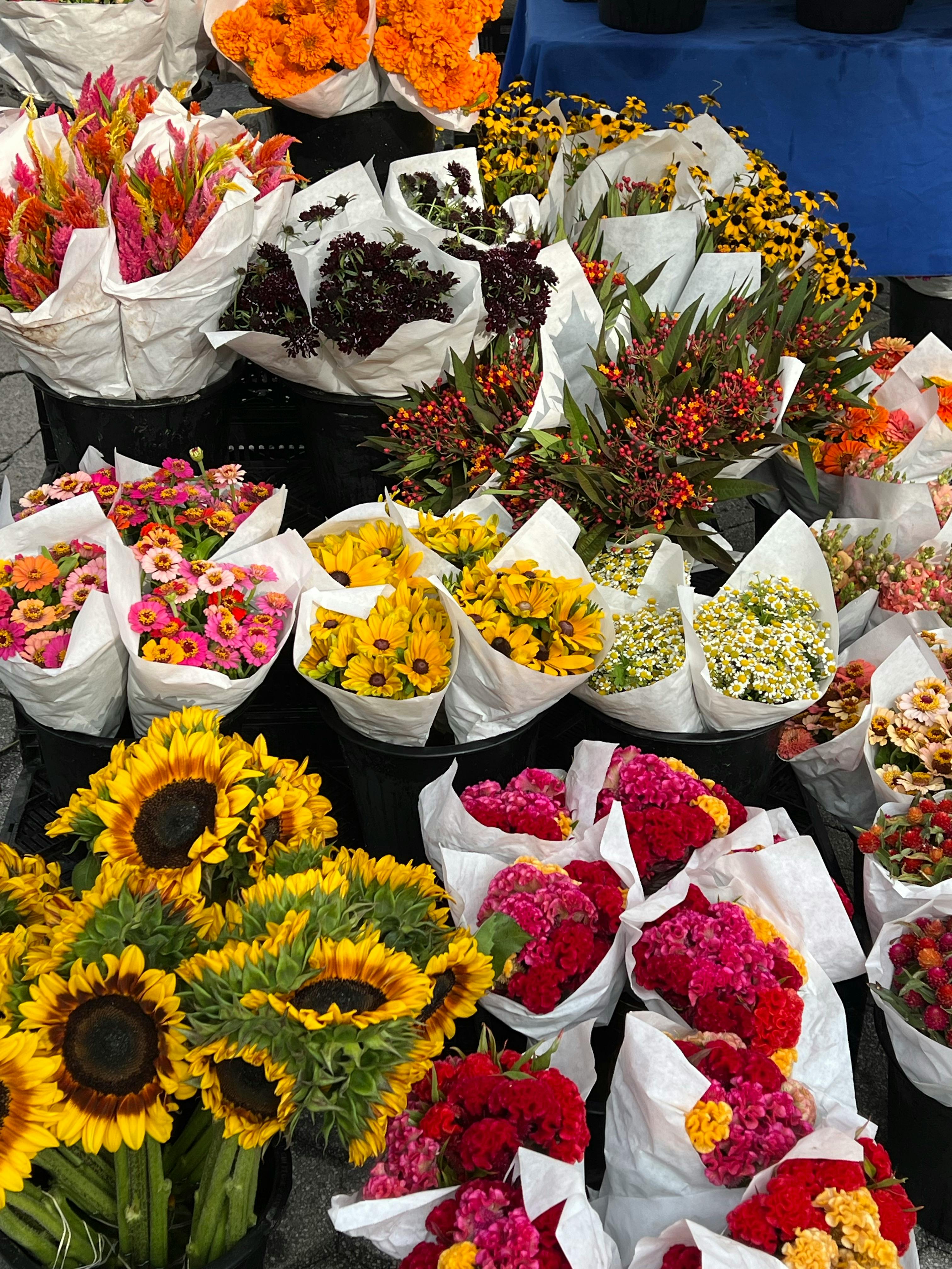 a bunch of flowers are displayed at a market