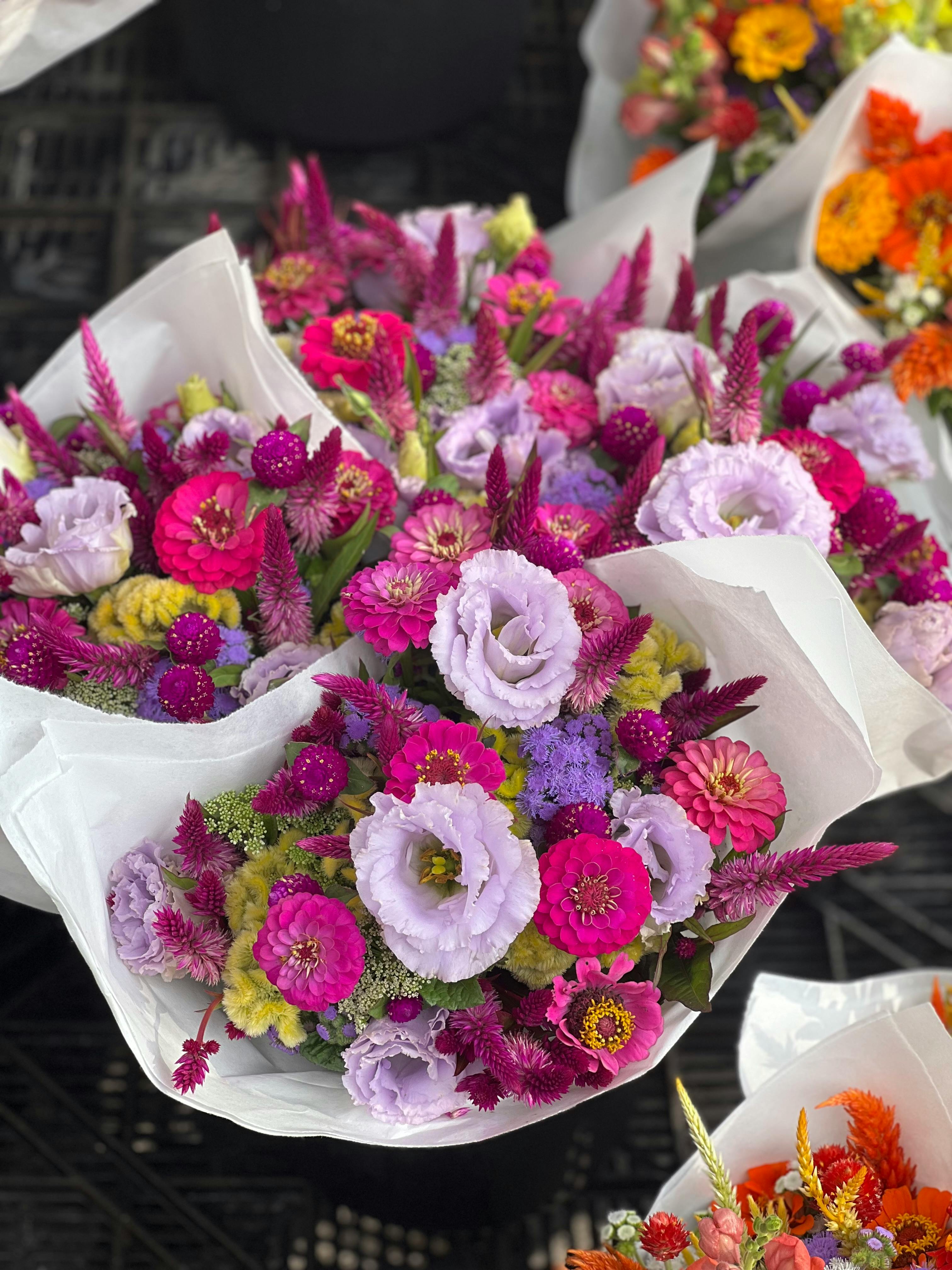[ColoSach]-vibrant-floral-bouquets-featuring-pink-and-purple-flowers-arranged-in-white-paper,-perfect-for-celebrations.