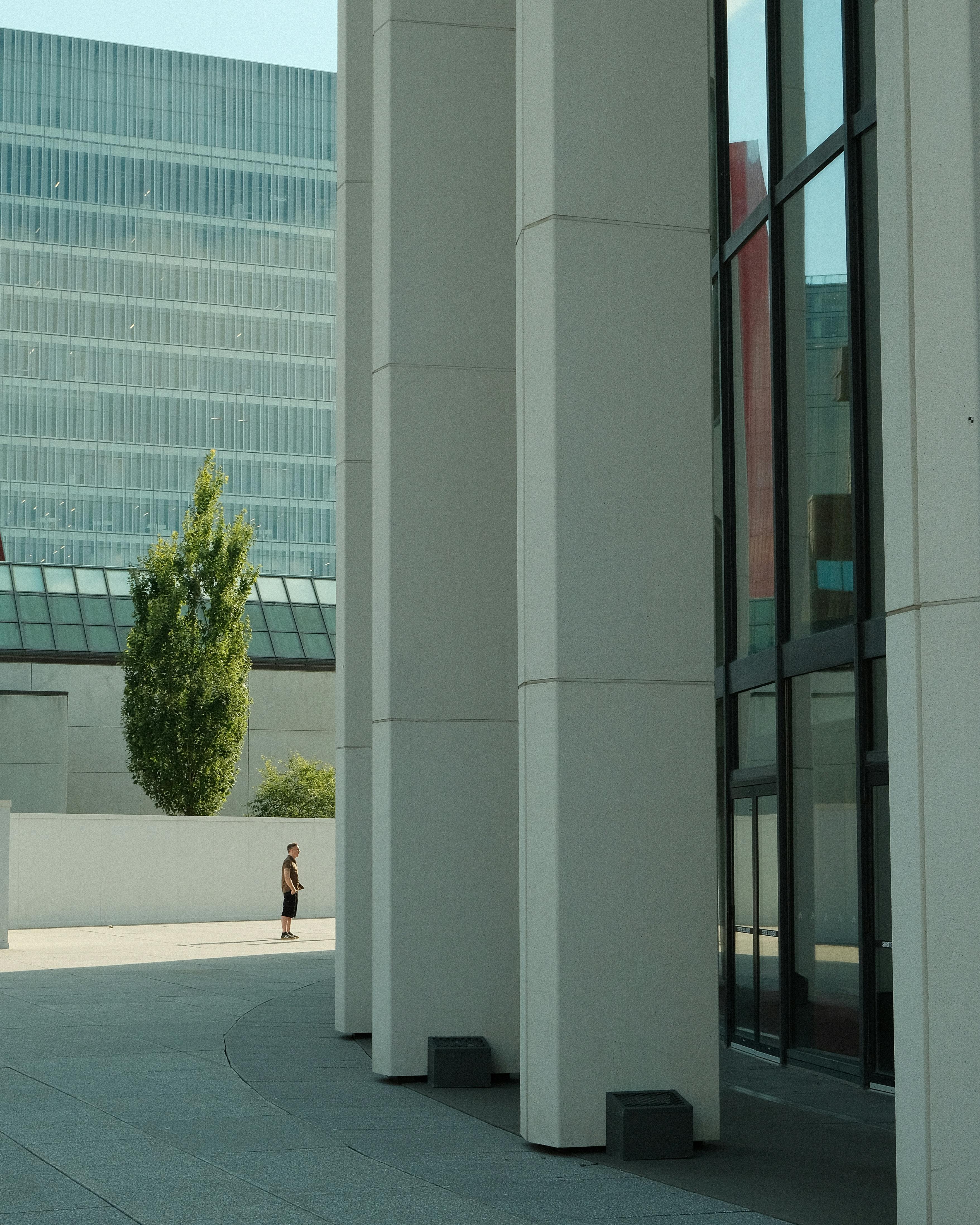 Contemporary urban scene showcasing modern buildings and glass reflections.