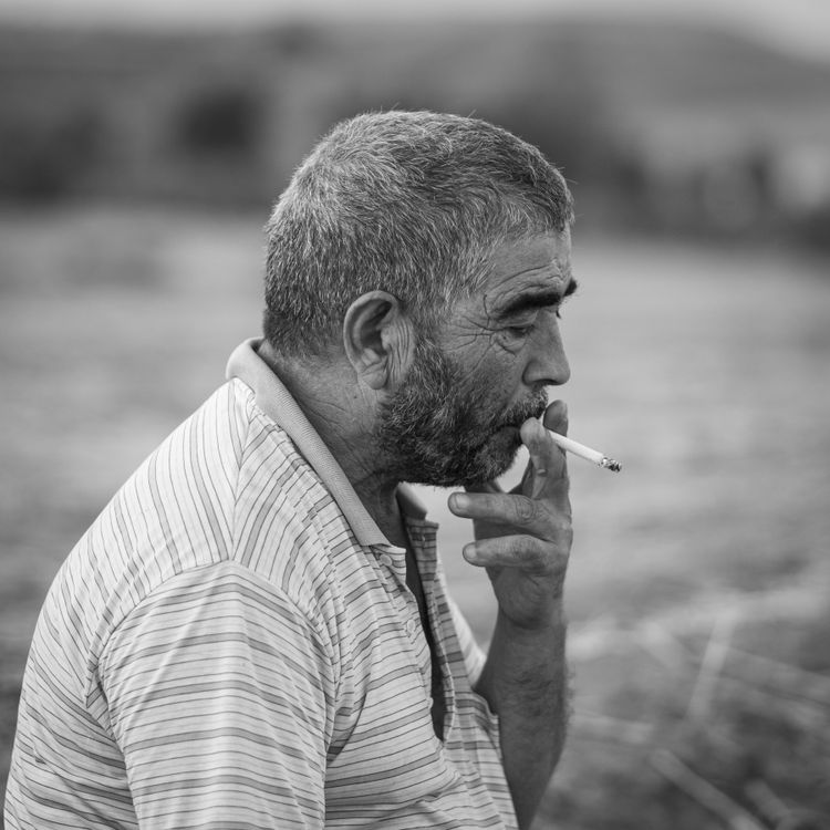 Old man smoking a cigarette · Free Stock Photo