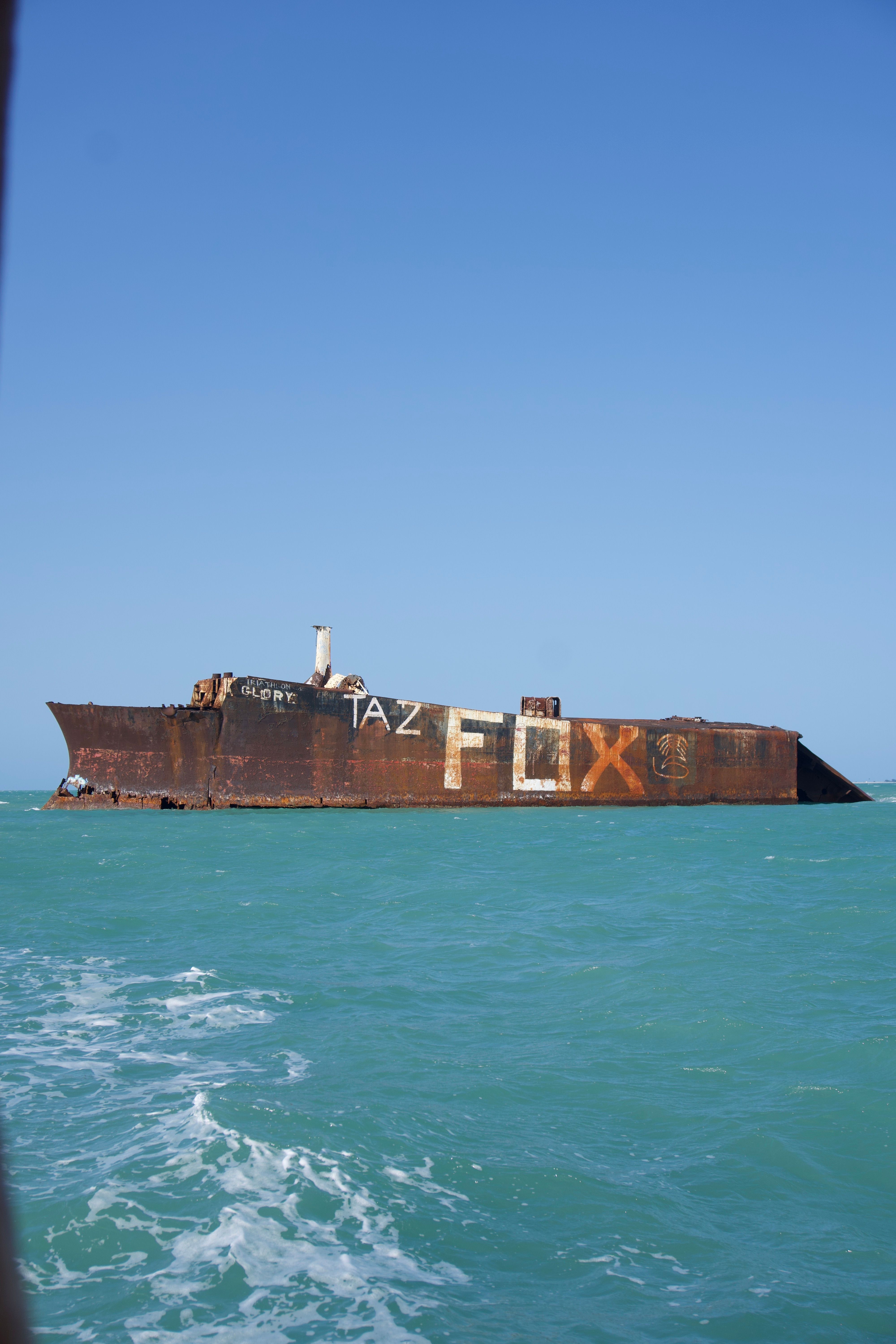 A large ship in the ocean with a large sign on it · Free Stock Photo
