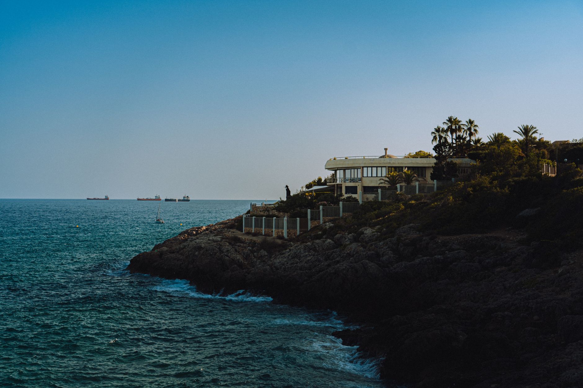 A minimalist ultra-luxury villa nestled in a remote, unmapped coastal landscape focusing on privacy and the horizon.