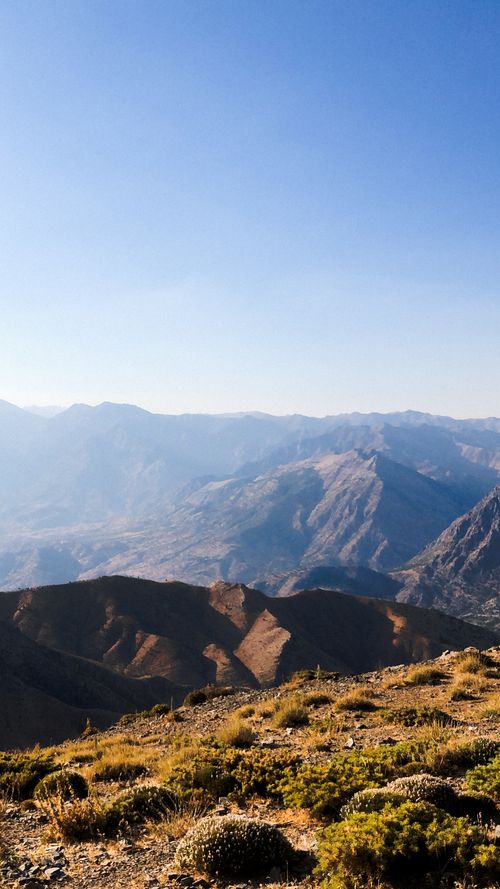 Free Breathtaking view of rocky mountains at sunrise with a clear blue sky, perfect for nature lovers. Stock Photo