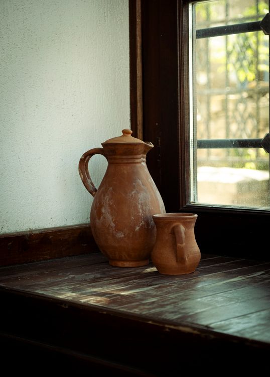 Pitcher In House Window Two clay pitchers sit on a window sill · Free Stock Photo