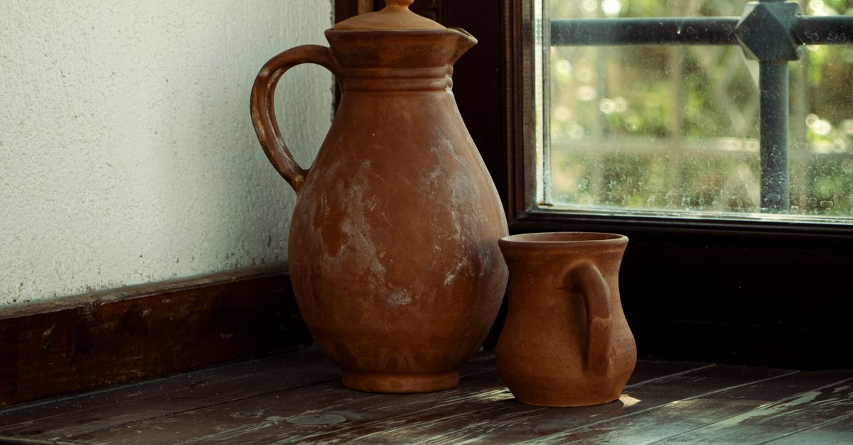 Pitcher In House Window A pottery jug and pitcher sit on a window sill · Free Stock Photo