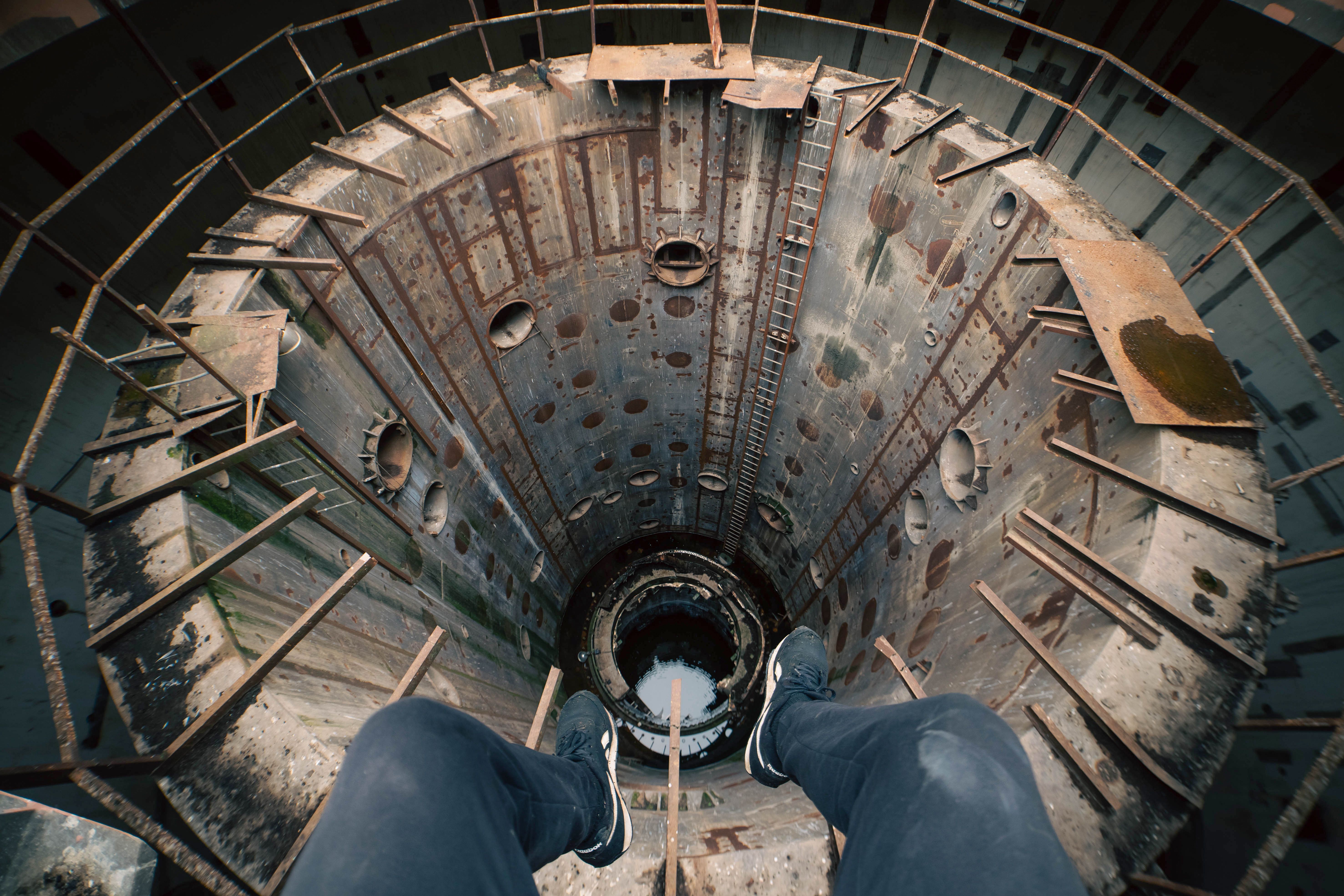 View from above of an abandoned industrial structure showing rust and decay.