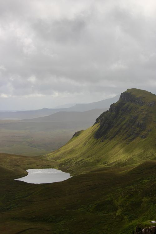 Free A tranquil mountain scene with a small lake under cloudy skies. Stock Photo