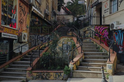 Free Vibrant graffiti-covered stairs in Istanbul's urban alleyway, showcasing dynamic city life. Stock Photo