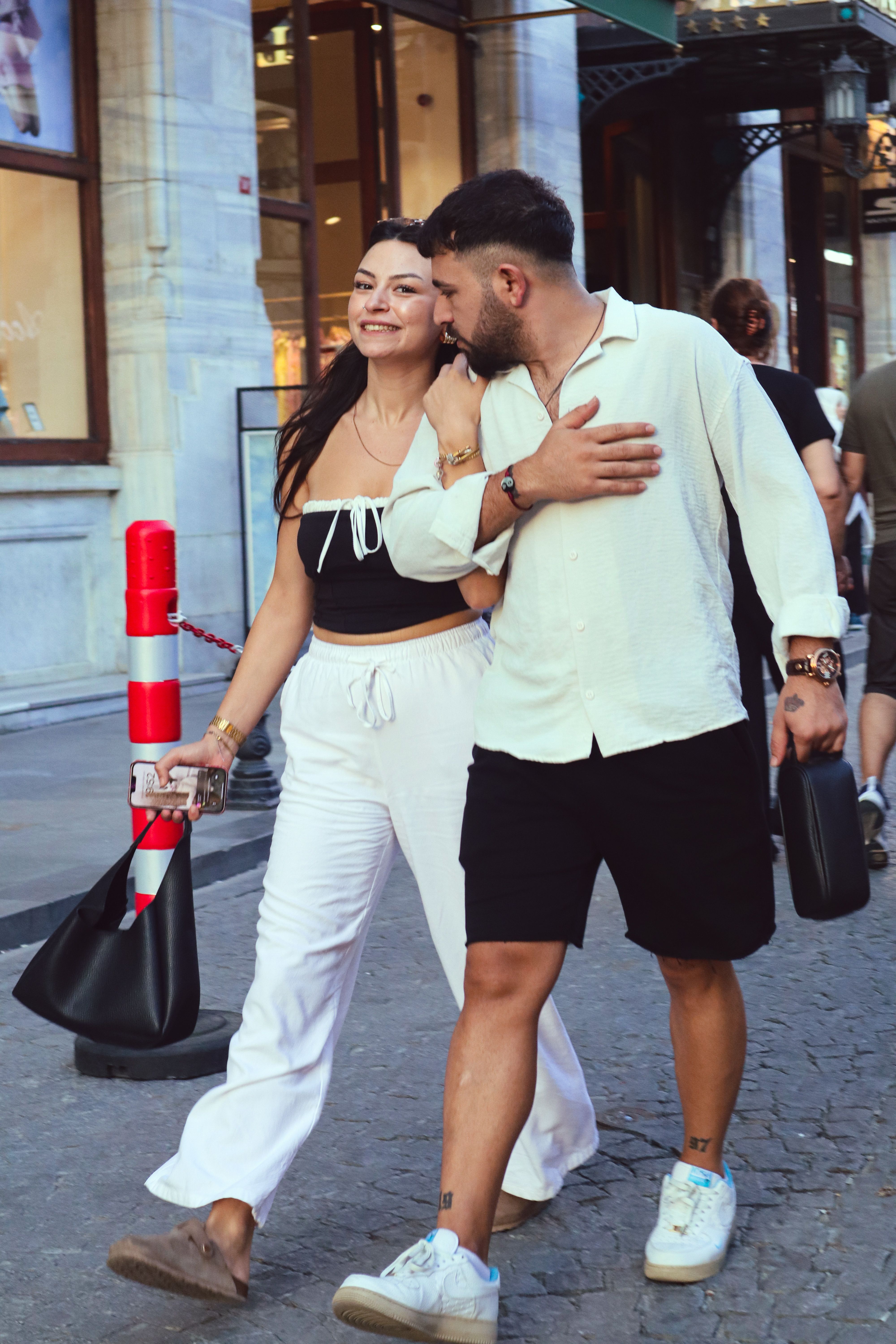 A fashionable couple walking in the vibrant streets of İstanbul, Türkiye.