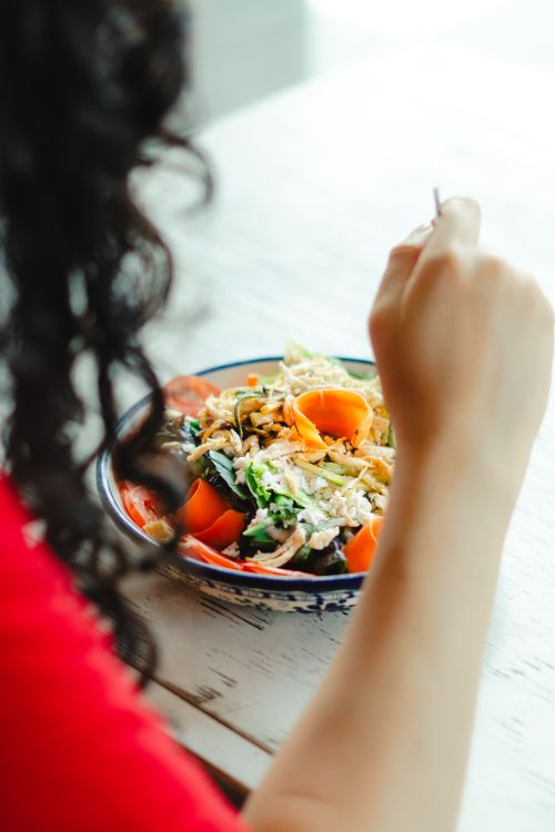 Free A woman enjoys a nutritious salad with fresh veggies indoors in Mexico. Stock Photo